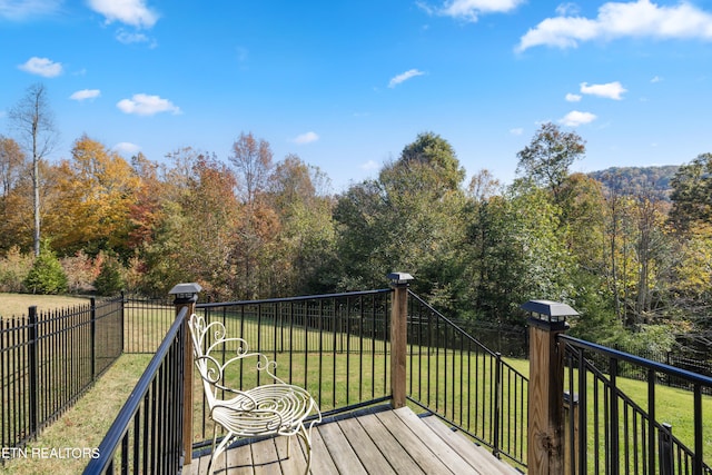 wooden terrace with a yard