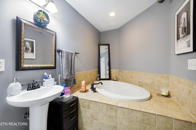 bathroom featuring tiled tub