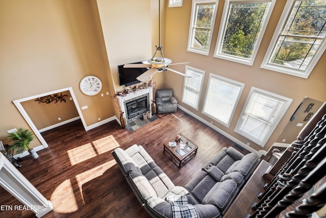 living room featuring dark hardwood / wood-style floors and ceiling fan