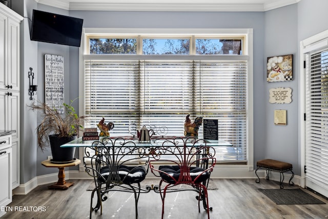 dining room with crown molding and hardwood / wood-style flooring