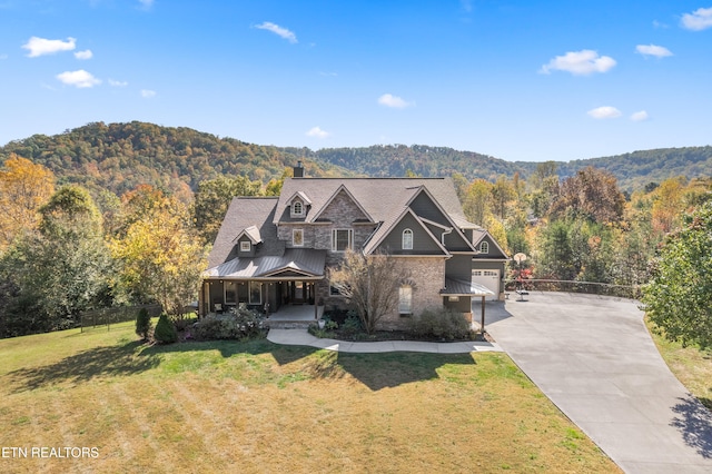 craftsman-style house featuring a front lawn and a mountain view