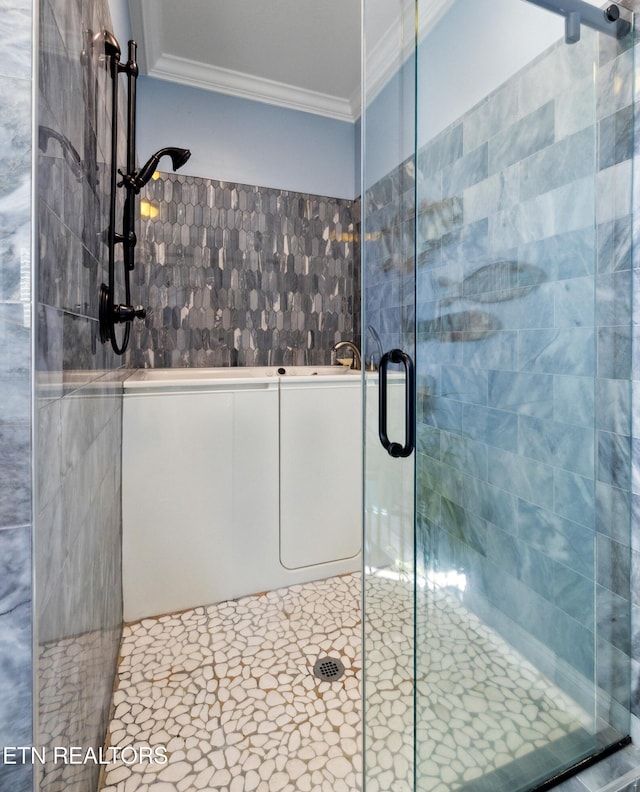 bathroom featuring crown molding, tile patterned floors, walk in shower, and tile walls