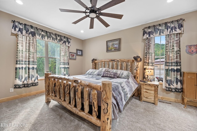 bedroom with ceiling fan, carpet, and multiple windows