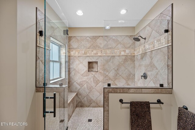 bathroom with tiled shower