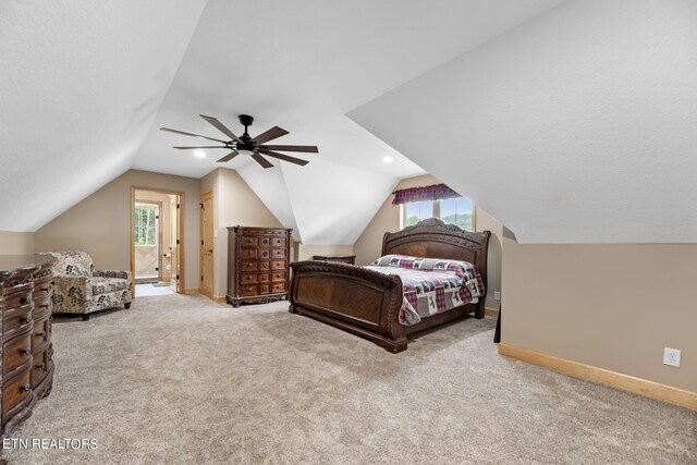 carpeted bedroom featuring ceiling fan, lofted ceiling, and multiple windows