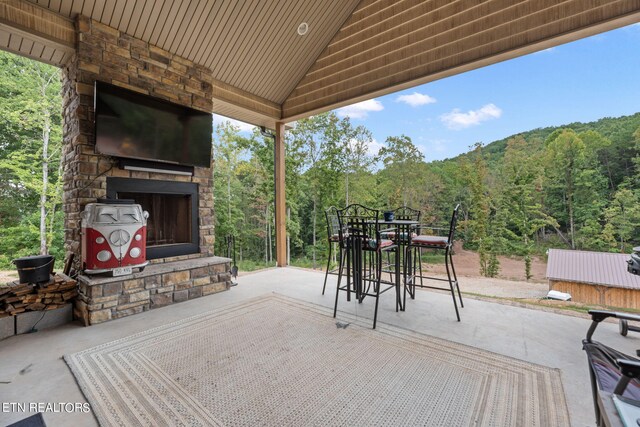 view of patio / terrace featuring an outdoor stone fireplace