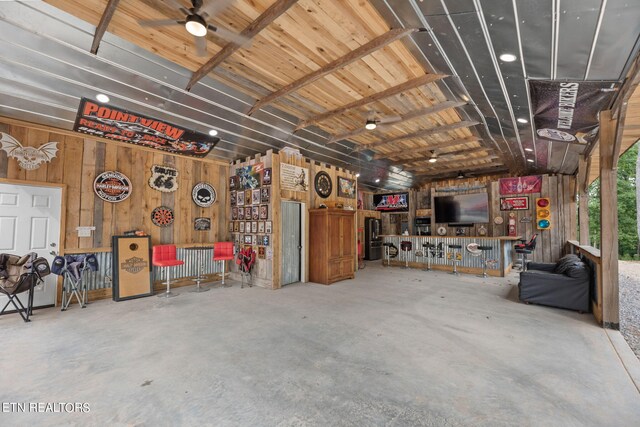 garage with wood walls and ceiling fan