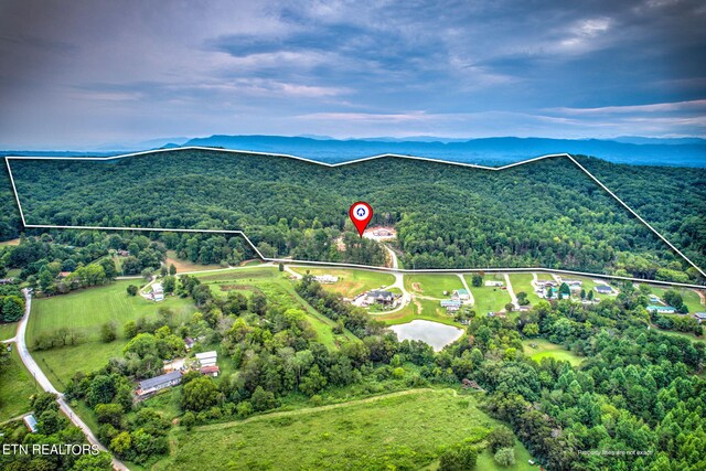 aerial view at dusk featuring a mountain view