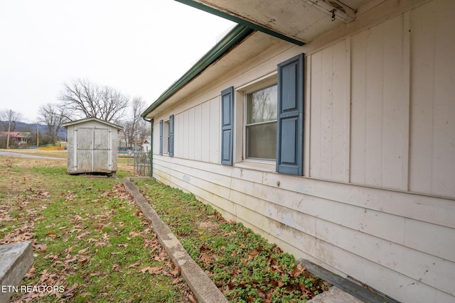 view of side of property featuring a shed