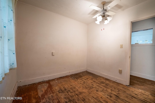 empty room featuring dark hardwood / wood-style flooring, ceiling fan, and ornamental molding