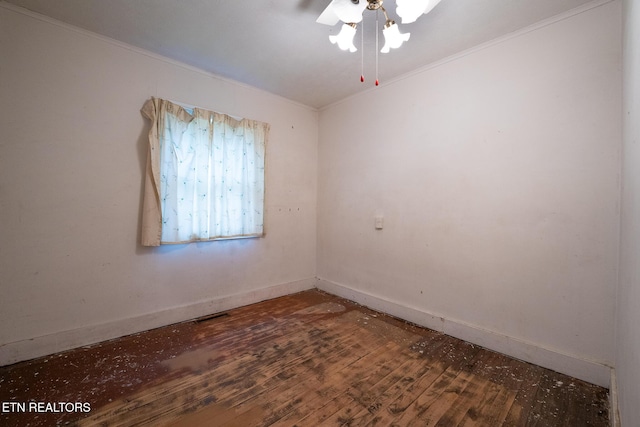 spare room featuring crown molding, dark hardwood / wood-style flooring, and ceiling fan