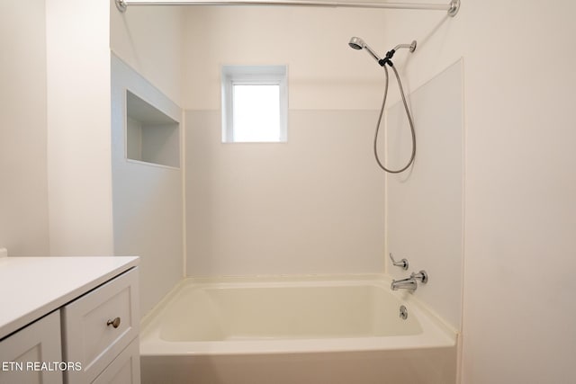 bathroom featuring vanity and  shower combination