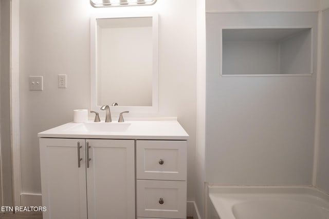 bathroom with vanity and a bathtub