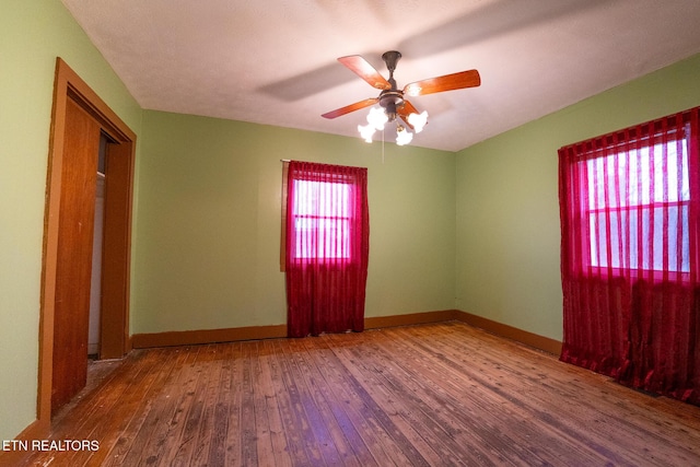 empty room featuring ceiling fan and hardwood / wood-style floors