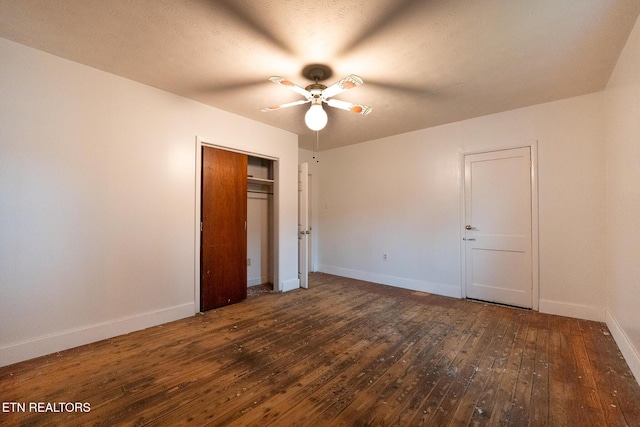 unfurnished bedroom with dark hardwood / wood-style floors, ceiling fan, and a textured ceiling