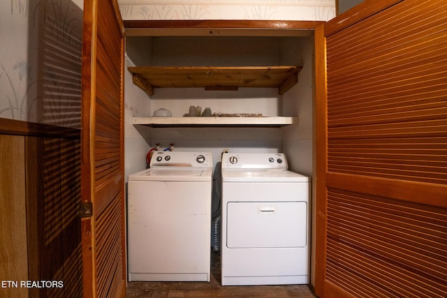 laundry area with wood walls and washer and dryer