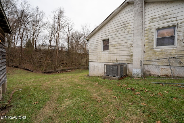 view of home's exterior featuring a yard and central AC unit