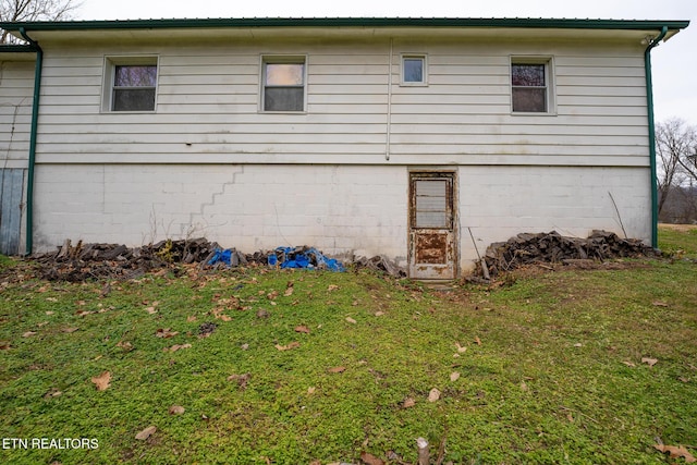 view of side of property with a lawn