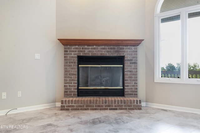 interior details with a brick fireplace