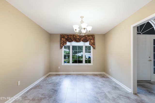 unfurnished room featuring a notable chandelier