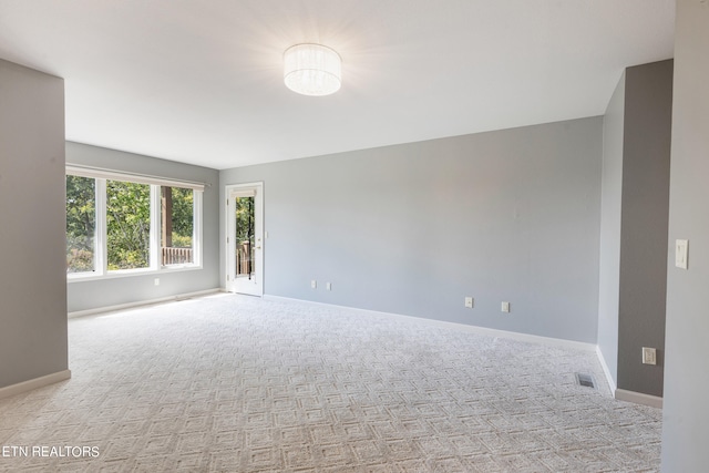 unfurnished room featuring light colored carpet