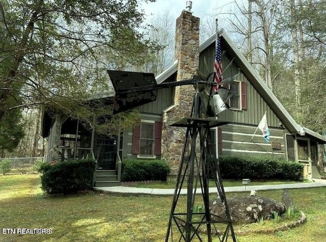 back of property featuring a lawn