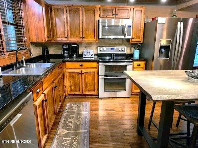 kitchen with light wood-type flooring, sink, and stainless steel appliances