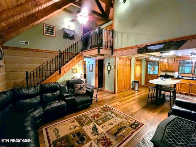 living room featuring ceiling fan, light wood-type flooring, wood ceiling, and high vaulted ceiling