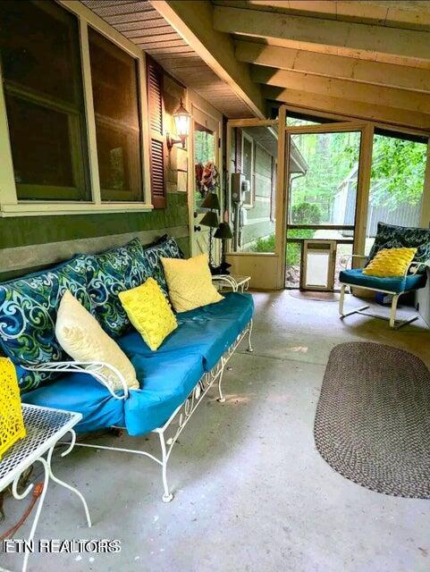 sunroom featuring lofted ceiling