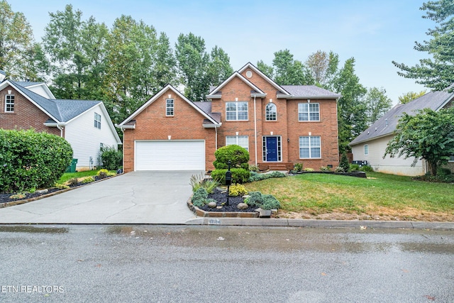 view of front of home featuring a front yard and a garage