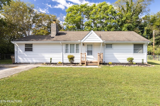 ranch-style home featuring a front yard