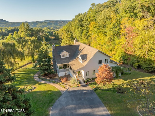 cape cod house featuring a front yard, a mountain view, and a porch