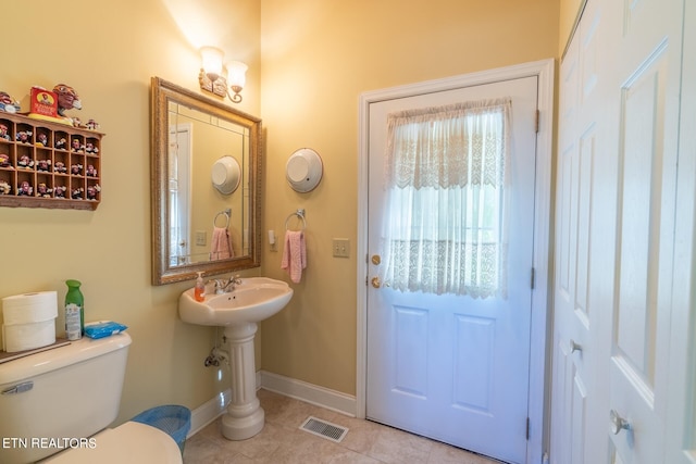 bathroom with tile patterned flooring and toilet