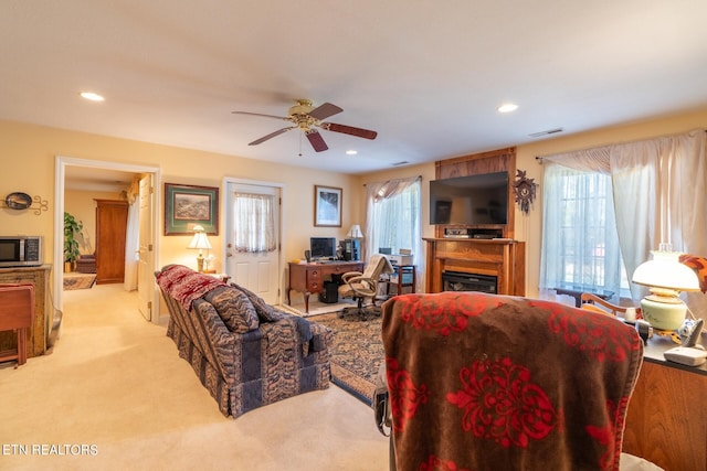 living room with ceiling fan and light carpet