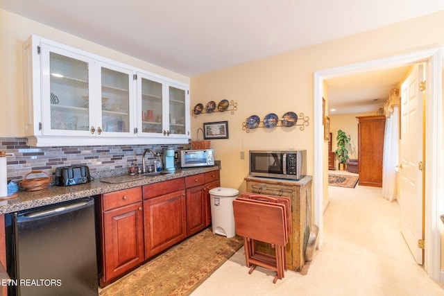 kitchen with light carpet, stainless steel appliances, sink, and decorative backsplash