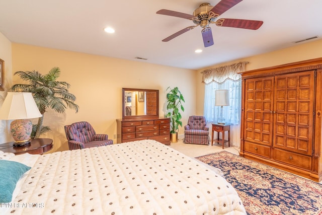 bedroom featuring light colored carpet and ceiling fan