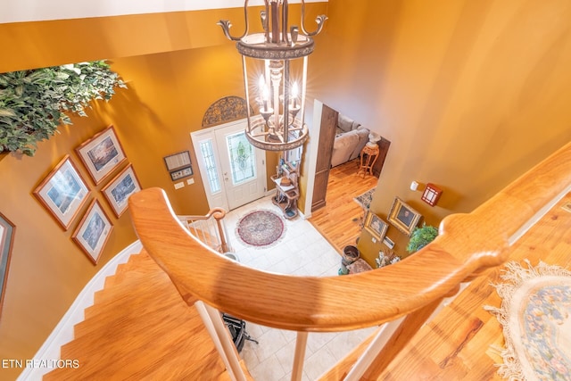 foyer with a towering ceiling and wood-type flooring