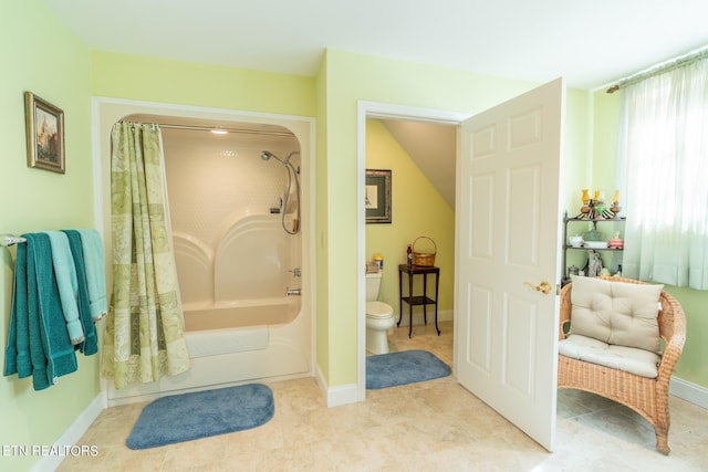 bathroom featuring shower / bath combo with shower curtain, toilet, and tile patterned floors