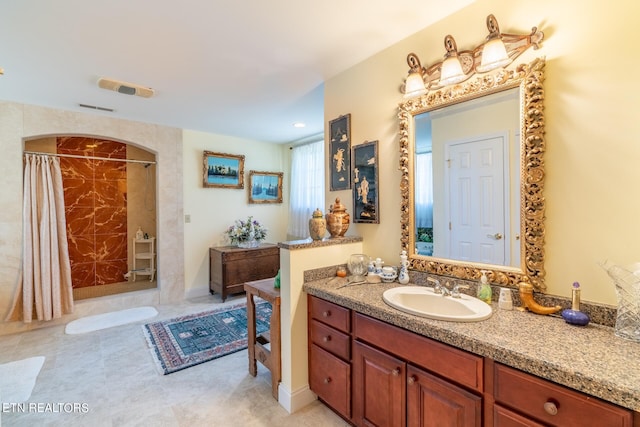 bathroom with a shower with curtain and vanity