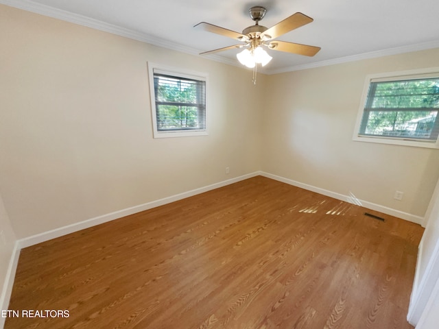 spare room with ceiling fan, hardwood / wood-style flooring, and crown molding