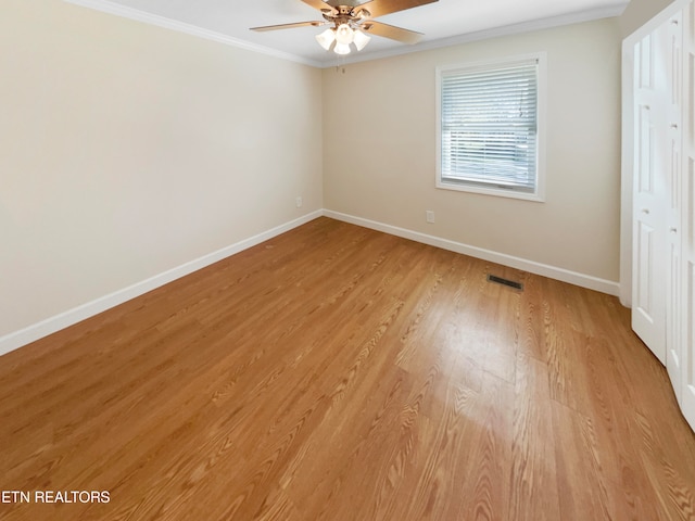 unfurnished bedroom with ornamental molding, ceiling fan, and light hardwood / wood-style floors