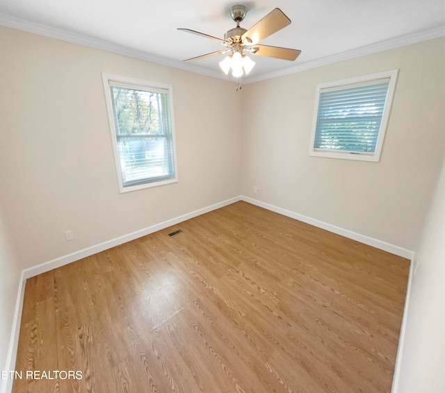 spare room with crown molding, hardwood / wood-style flooring, and ceiling fan