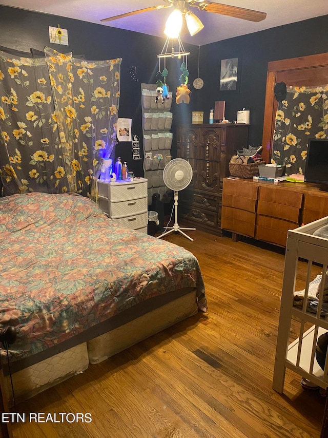 bedroom featuring ceiling fan and hardwood / wood-style flooring