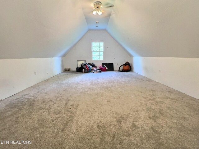 bonus room with lofted ceiling, ceiling fan, and carpet flooring