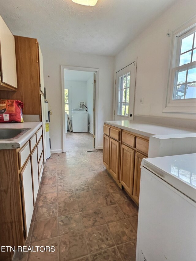 kitchen with a textured ceiling and sink