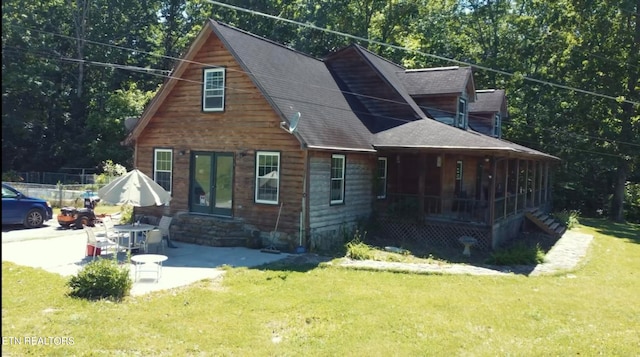 view of front of property with a patio and a front yard