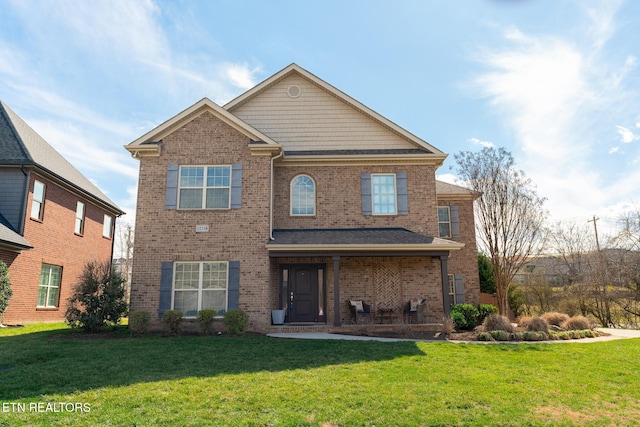 view of front facade featuring brick siding and a front lawn