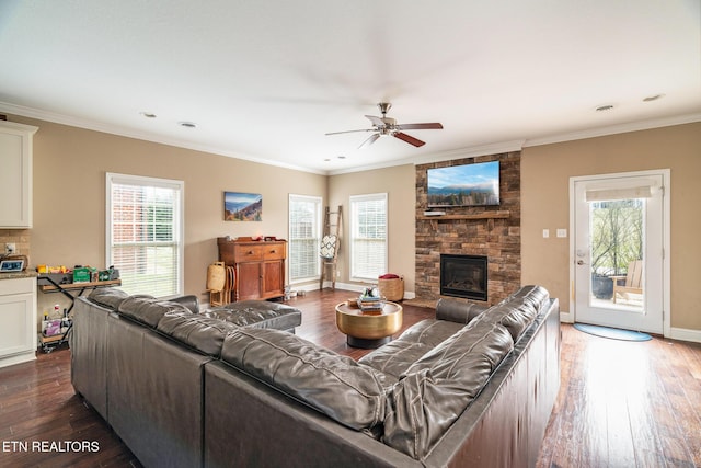 living area featuring baseboards, a fireplace, ornamental molding, and wood finished floors