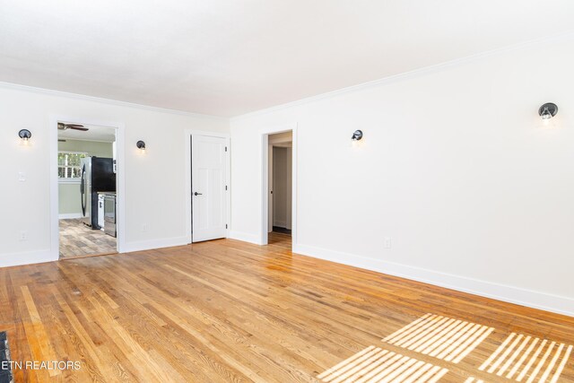 unfurnished room featuring crown molding and hardwood / wood-style floors