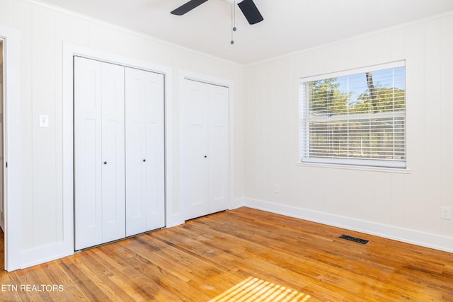 unfurnished bedroom featuring light wood-type flooring, crown molding, and ceiling fan